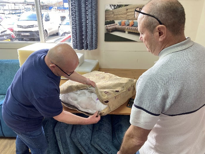 The customer's cushion is examined to determine the existing fillings.