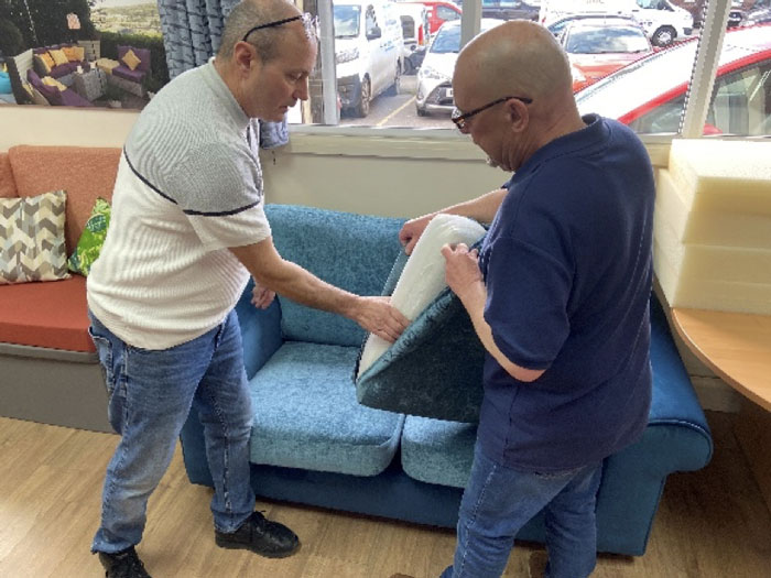 An expert staff member demonstrates and explains the cushion refilling process.